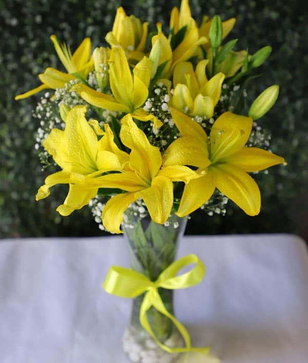 Shining Yellow Asiatic Lily In Glass Vase